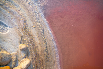 The shore of a salty pink lake. Salt formation. Natural background