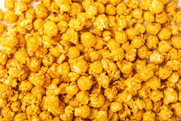 Delicious caramel popcorn isolated on white background. Cinema and entertainment concept. Movie night with popcorn. Cheese and caramel popcorn. Delicious appetizer, snack. Banner