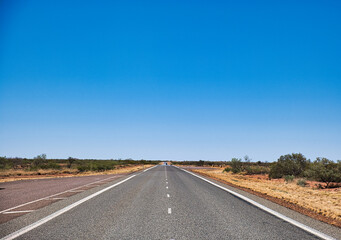 Straight highway with a small rest area in the remote outback of Western Australia, shire of Ashburton
