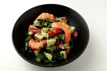Salad of king prawns, avocado, cucumber, tomato and herbs. Isolated background.