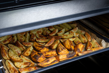 Crispy oven-baked potatoes. Delicious potatoes with for dinner just out of the oven
