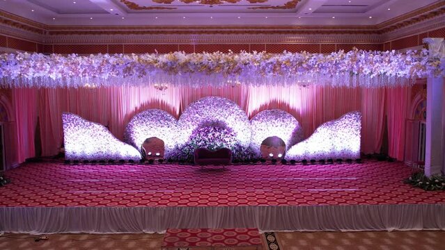 Delhi, India 9th May 2024: An elegantly and grand traditional setup stage with flowers for the wedding couple to sit and receive blessings from the guests. Luxury Wedding venues and decorations