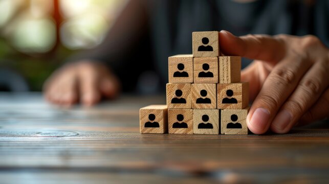 Hand Building A Team Hierarchy With Wooden Blocks
