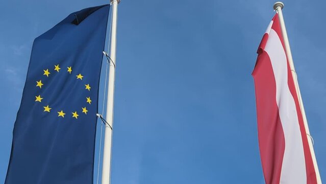 EU European Union Flag and Austrian Flag and Blue Sky