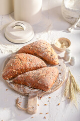 Brown and tasty triangular buns freshly baked in home bakery.