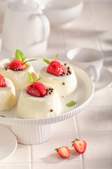 Delicious cheesecake monoportion decorated with strawberries and sprinkles.