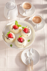 Tasty cheesecake monoportion served with coffee in summer.