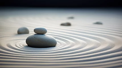 Minimalist Japanese zen garden made of rocks & stones resting on white sand raked into concentric circles reminiscent of ripples in water. The focus is on two smooth pebbles, one on top of the other.