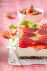Sweet strawberry cheesecake with vanilla cream and jelly.