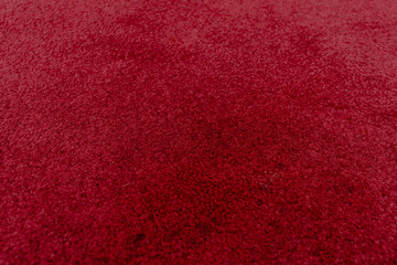 Red floor carpet, solid writing wall paper background.