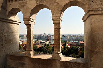 View through a stone window of the Fisherman's Bastion onto the Hungarian Parliament Building at...