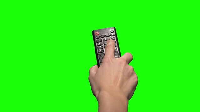 Female hand changes the channel with the remote control. Green Screen 4k