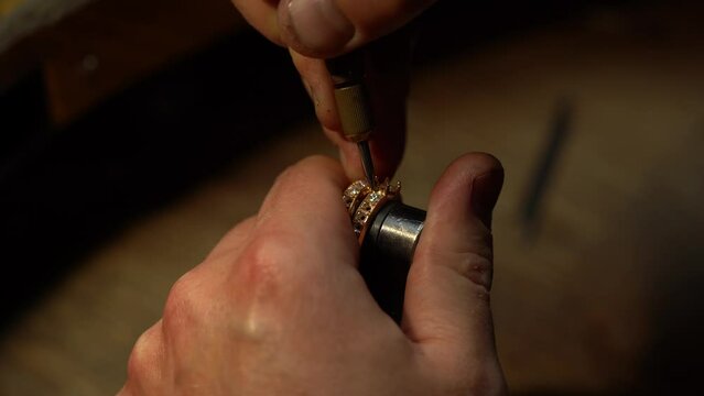 craftsman making diamond ring. hand made jewelery. Put diamond gem ring. diamond ring production. hand made in craftsman workshop close up. 