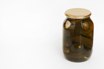 A jar of rolled green cucumbers with a metal lid.