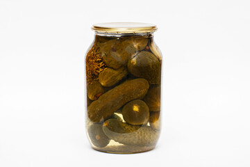 A jar of rolled green cucumbers with a metal lid.
