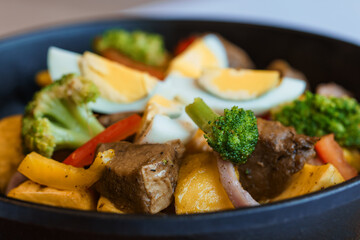 Stewed meat with vegetables and mushrooms