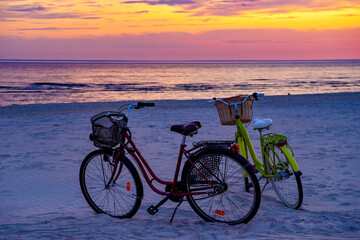 Fototapeta premium Bikes on the beach at sunset. Liepaja, Latvia