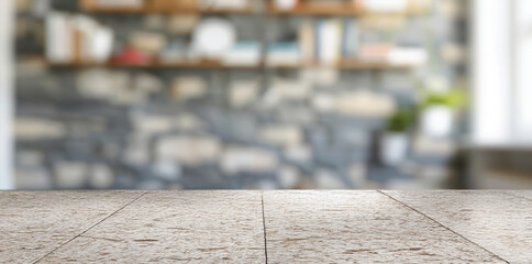 Fototapeta premium Empty stone countertop with blurred bookshelf background. Rustic stone table with a blurred bookshelf background, ideal for product placement.