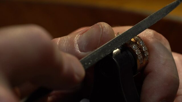 craftsman making diamond ring. hand made jewelery. Put diamond gem ring. diamond ring production. hand made in craftsman workshop close up. 