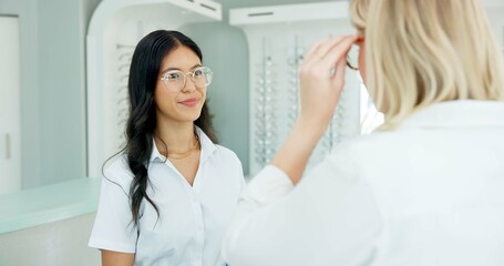 Obraz premium Vision, optometry and help customer with glasses for eye health, wellness or care. Ophthalmology, lens and woman trying spectacles in consultation for choice or eyesight correction of client at store