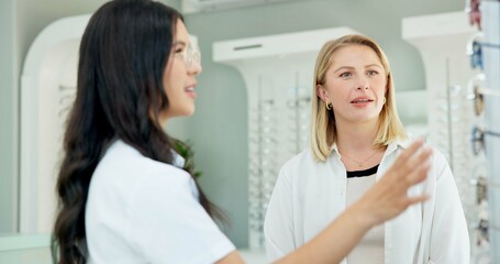 Fototapeta premium Choice, optometrist and help customer with glasses for eye health, wellness or care of doctor. Ophthalmology, lens frame and woman assist client for advice, spectacles or eyesight correction at store