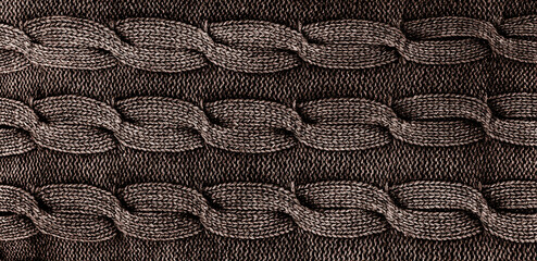 Close-up of grey knitted fabric with twists