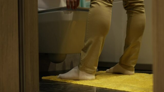 Urinary tract disease. A man relieves himself near the toilet. A man has problems with the genitourinary system and frequent urination. Prostate adenoma in humans.