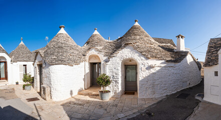 Famous historic dry stone trulli houses with conical roofs in Alberobello, Italy.