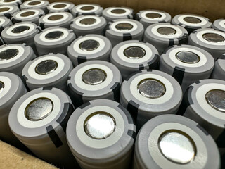 A pile of batteries is vertically stacked on top of each other