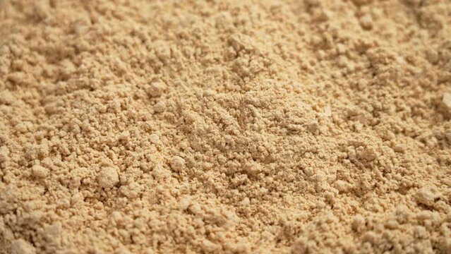 Peanut flour falling in slow motion. Gluten free baking nut powder is a versatile ingredient for baking. Rotation