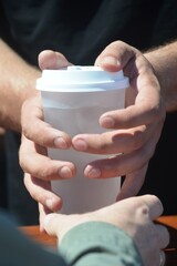 close up of a hand holding a cup