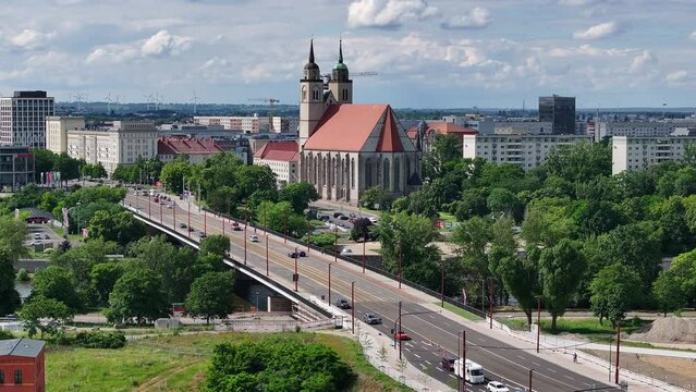 Shot of the new flow bridge over the Elbe river in Magdeburg and Johannis Church in the background. Flight from the left to the right side. Bridge reopened to traffic after construction work.