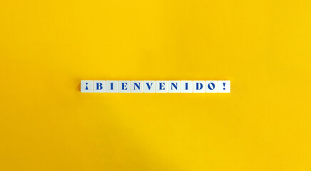 Bienvenido (Welcome) in Spanish Banner. Text on Block Letter Tiles on Yellow Background. Minimal...