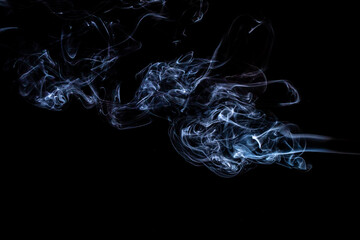 puffs of white smoke on a black background