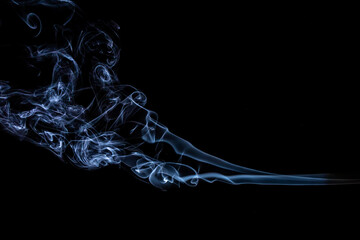 puffs of white smoke on a black background