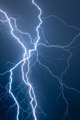 Multi branched lightning bolts against a dark blue background