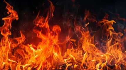 Fototapeta premium Texture of fire flames on black background. Burning red hot sparks