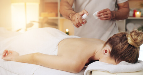 Hand, oil spray and back massage on woman at spa for wellness, relax and stress relief with masseuse. Luxury, therapy and physical therapist with product for body, skin and zen muscle therapy