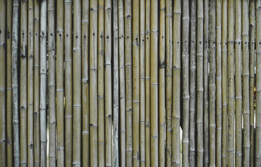 Empty old dry brown natural bamboo timber wall, slat, fence seamless background for product montage. Texture background, copy space for work, banner, wallpaper for design.