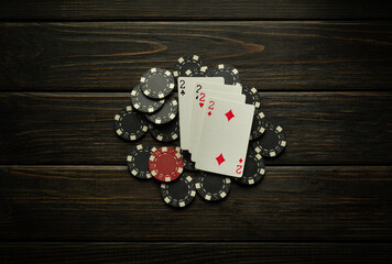 Four of a kind or quads playing cards and chips on a vintage club table. Luck or winning in poker
