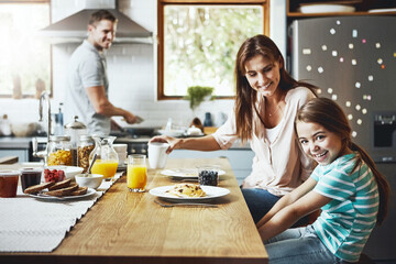 Love, breakfast food and happy family with children, mother and father, bonding and prepare ingredients. Morning pancakes, cooking and hungry woman, man and daughter in home kitchen eating meal