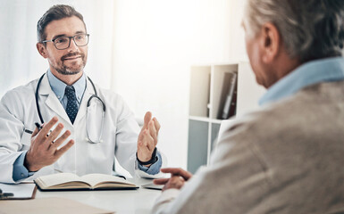 Fototapeta premium Consultation, man and doctor in office with advice, help and discussion for health insurance. Clinic, senior patient and medical professional at desk with support, trust and healthcare at checkup