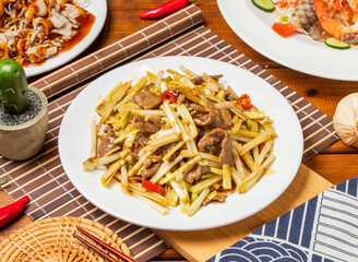 Chive beef with red pepper and chopsticks served in dish isolated on table side view taiwanese food