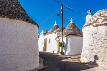 Famous historic dry stone trulli houses with conical roofs in Alberobello, Italy.