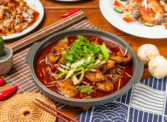 Chongqing Boiled Fish noodles with red chilli, spring onion coriander and chopsticks served in dish isolated on table side view taiwanese food