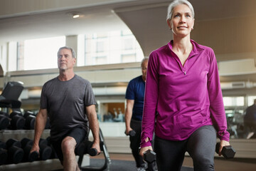 Fitness, weights and mature people in gym for workout, training and exercise class for health....
