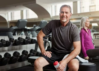 Gordijnen Fitness, gym and portrait of old man relax with water bottle for training, exercise and workout. Sports, retirement and person listening to music, audio and podcast for wellness, health and resting © ReadyAtTheEase/peopleimages.com