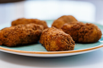 Chicken nuggets in batter on a plate