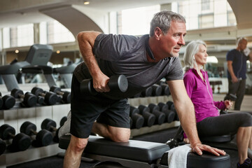 Plakat Fitness, weights and senior man in gym for workout, training and cardio exercise for healthy body. Retirement, sports and person with dumbbell equipment for wellness, muscle strength and mobility