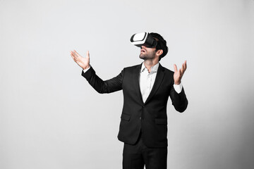 Business man looking data analysis by using VR glasses. Project manager checking business strategy by enter in metaverse or virtual reality world while wearing suit at white background. Deviation.